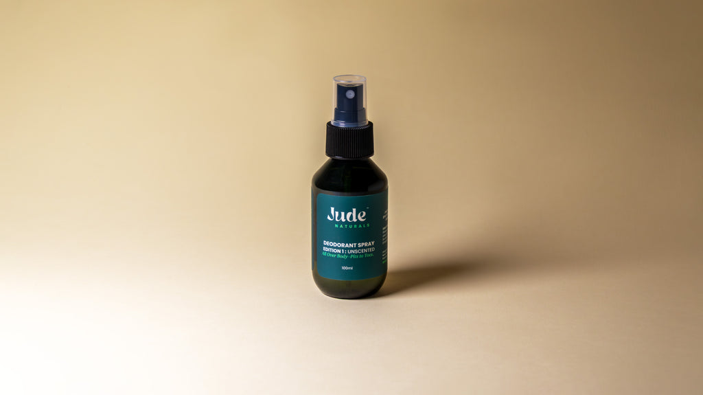 Jude Naturals spray deodorant with mineral salt formula on beige background. 