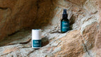 Jude Naturals deodorant bundle set with 100ml spray and 50ml roll-on, edition 1 unscented set on natural rock surface background. 